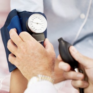 Pair of Human Hands Checking the Blood Pressure of a Patient